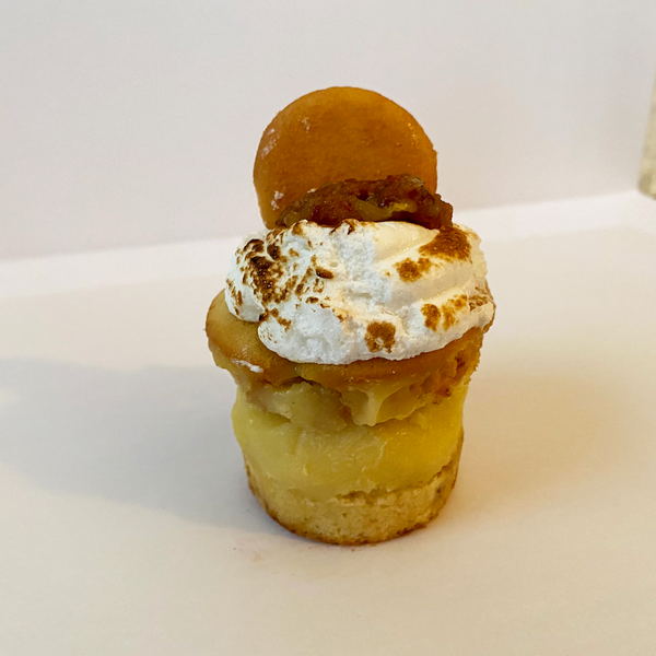 Banana Pudding stacked cupcake: Banana cupcake with wafer cookie bottom split and filled with old fashion vanilla custard and topped with lightly toasted meringue, caramelized bananas, and a wafer cookie